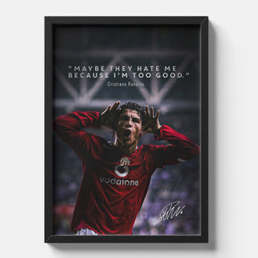 Framed poster of a soccer player in a red jersey with a quote, on a white wall.